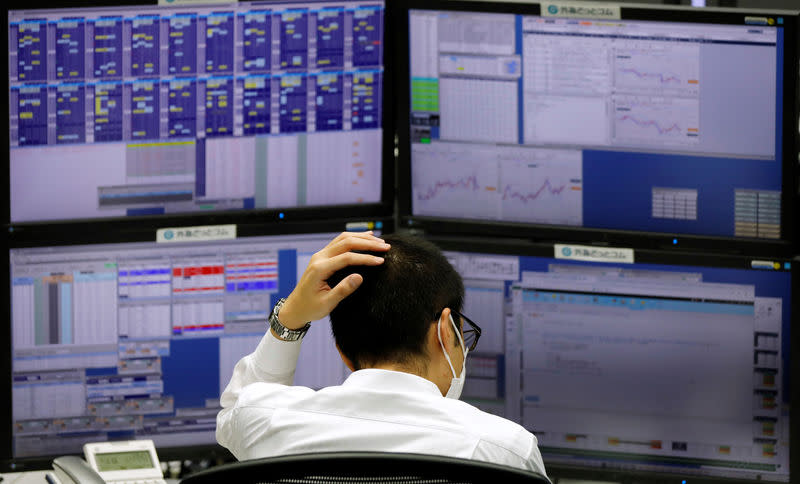 An employee of a foreign exchange trading company works in front of monitors in Tokyo, Japan November 7, 2018. REUTERS/Toru Hanai