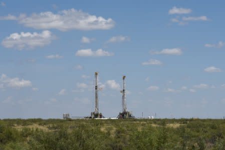 FILE PHOTO: Horizontal drilling rigs operate in the Permian Basin oil production area near Wink, Texas U.S. August 22, 2018. REUTERS/Nick Oxford