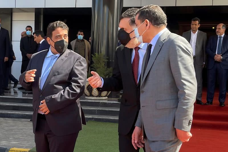 Libya's Prime Minister Abdulhamid Dbeibeh, Libya's internationally recognized former Prime Minister Fayez al-Sarraj, and Mohammed al-Menfi, Head of the Presidency Council, arrive ahead of the handover ceremony in Tripoli