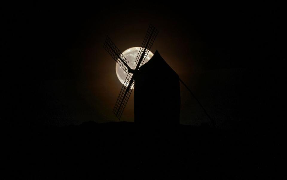 The super blue moon rising behind a windmill in Consuegra, Ciudad Real province, Spain on Aug. 30, 2023.<span class="copyright">Thomas Coex—AFP/Getty Images</span>