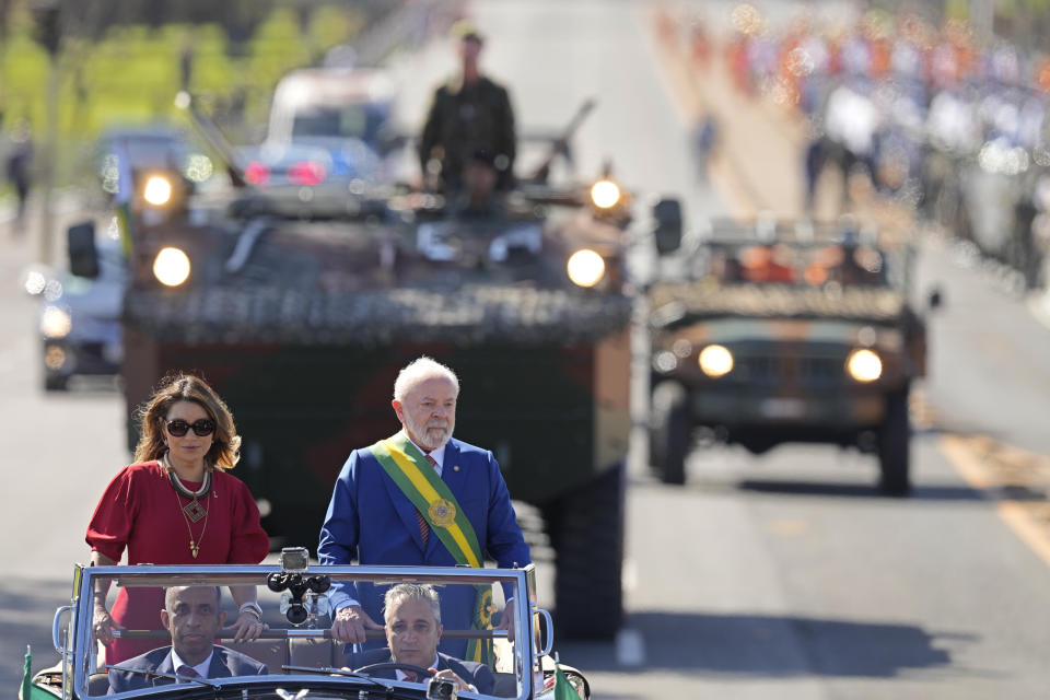 Brazilian President Luiz Inacio Lula da Silva and first lady Rosangela da Silva stasnd in an open car at the start of a military parade on Independence Day in Brasilia, Brazil, Thursday, Sept. 7, 2023. (AP Photo/Eraldo Peres)