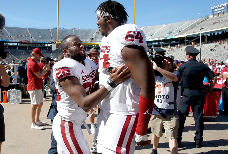 Oklahoma offensive lineman Wanya Morris (64) celebrates last year's win over Texas with then-Sooners running back Kennedy Brooks.