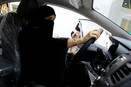 FILE PHOTO: A Saudi woman checks a car at the first automotive showroom solely dedicated for women in Jeddah, Saudi Arabia, Jan. 11, 2018. REUTERS/Reem Baeshen//File Photo