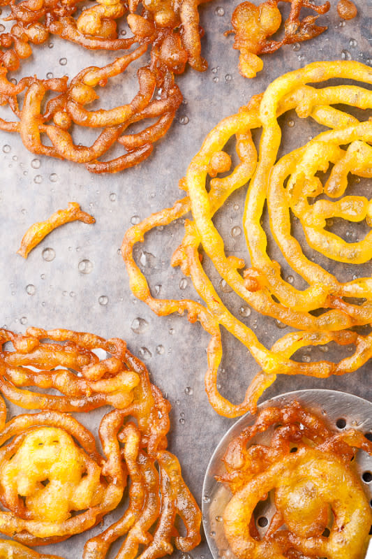 <p>Parade</p><p>Every grand festive meal should end with a delicious dessert, and Jalebi is undoubtedly one of the juiciest desserts of all time. It's kinda like a funnel cake, but dunked in sugar syrup.</p><p><strong>Get the recipe: <a href="/843386/prernasingh/10-indian-recipes-you-should-try-for-holi-the-festival-of-colors/" data-ylk="slk:Jalebi;elm:context_link;itc:0;sec:content-canvas" class="link rapid-noclick-resp">Jalebi</a></strong></p>