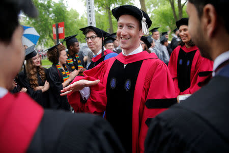 Facebook founder Mark Zuckerberg greets graduating students before receiving an honorary Doctor of Laws degree during the 366th Commencement Exercises at Harvard University in Cambridge, Massachusetts, U.S., May 25, 2017. REUTERS/Brian Snyder