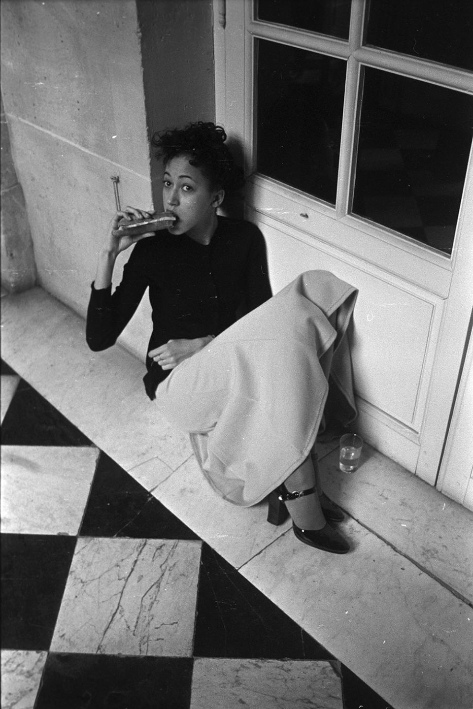 Outtake; Pat Cleveland eating a sandwich backstage during the fashion show to benefit the restoration of the Chateau of Versailles, five American designers matching talents with five French couturiers at the Versailles Palace on November 28, 1973 in Versailles, France...Article title: 'One night and pouf! It's gone!' (Photo by Fairchild Archive/WWD/Penske Media via Getty Images)