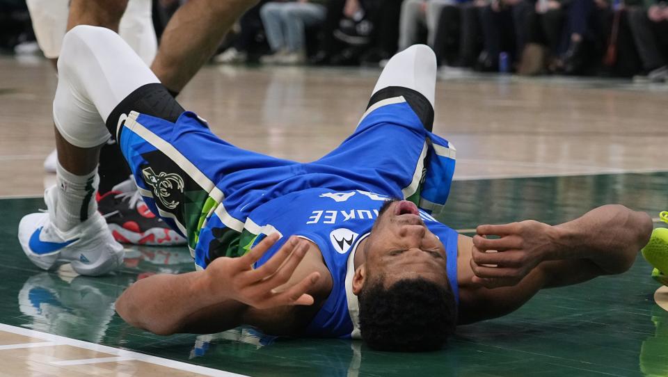 Bucks forward Giannis Antetokounmpo lies on the floor after being called for a foul during the second half.