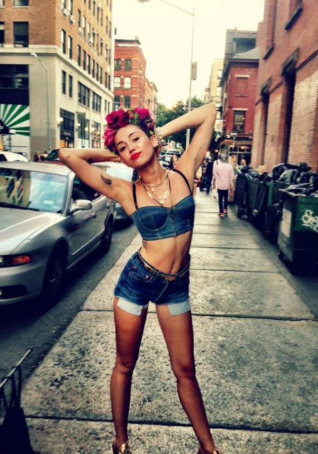 August 2013 Miley's loving the double denim in this candid Twitter snap taken in NYC