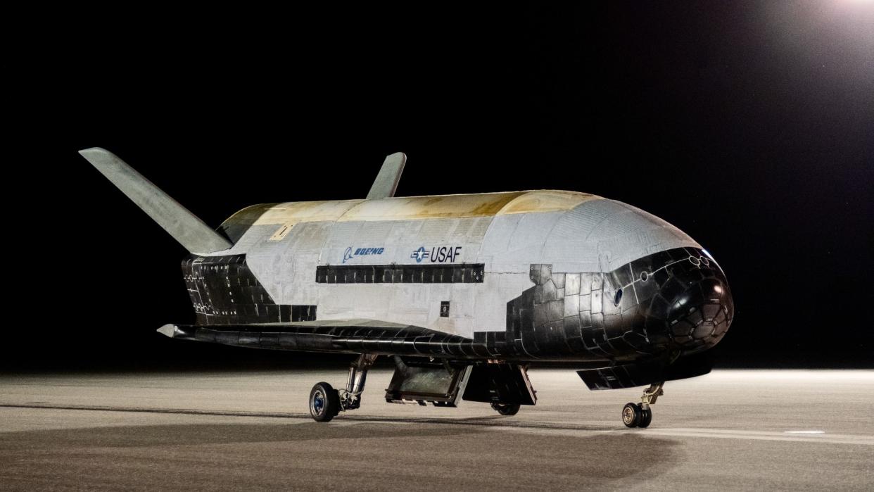  A white aircraft with no windows on a runway. 