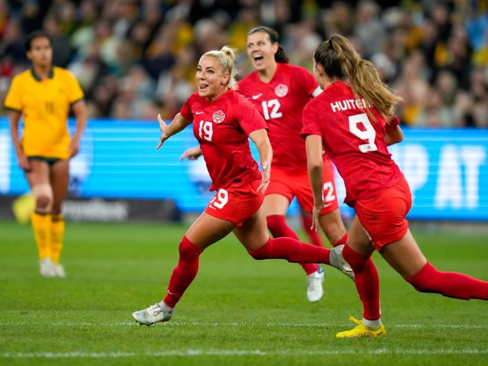 Canada's Adriana Leon, left, celebrates with Christine Sinclair, centre, and Jordyn Huitema after scoring her team's second goal during a friendly international soccer match between Canada and Australia in Sydney, Australia on Sept. 6, 2022. (Rick Rycroft/The Canadian Press - image credit)