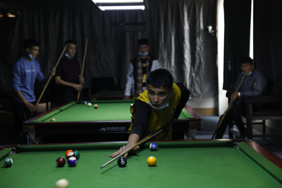 Young Uyghur men play billiards in Poksam county in northwestern China's Xinjiang Uyghur Autonomous Region on March 21, 2021. Four years after Beijing's brutal crackdown on largely Muslim minorities native to Xinjiang, Chinese authorities are dialing back the region's high-tech police state and stepping up tourism. But even as a sense of normality returns, fear remains, hidden but pervasive. (AP Photo/Ng Han Guan)