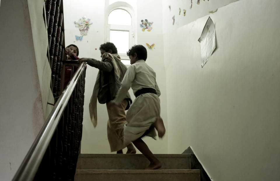 Boys run up the stairs at a rehabilitation center for former child soldiers in Marib, Yemen, in this July 25, 2018, photo. Boys come to center traumatized and mistrustful from their experiences on the battlefield. On his first day at the center, one said he was terrified, unsure what they would do to him. "But then I saw the teachers and they gave me a room to stay in. I felt good after that." (AP Photo/Nariman El-Mofty)