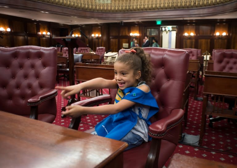 Mileny, a member of Girl Scout Troop 6000 checks out a seat in the City Hall Chambers in New York