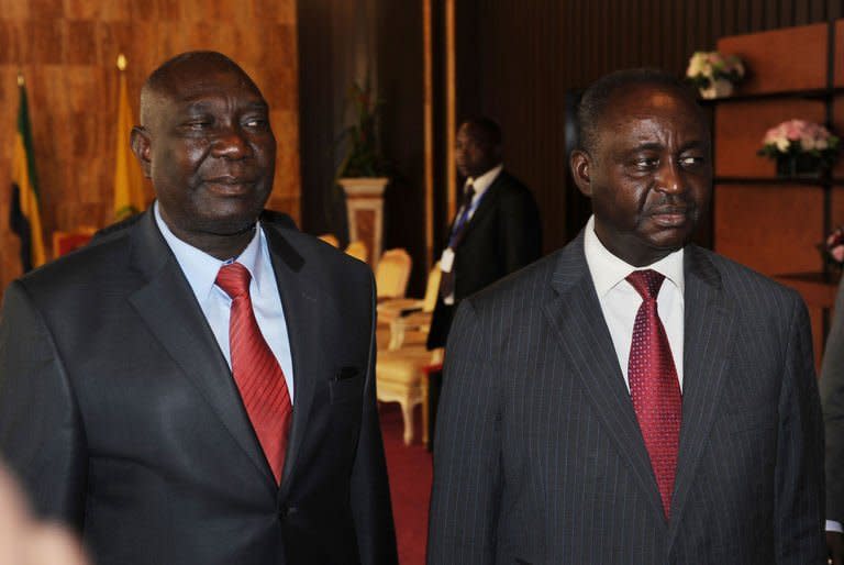 Central Africa's president Francois Bozize (R) stands next to Seleka rebel coalition chief Michel Djotodia (L) after talks in Libreville on January 11, 2013. Bozize on Saturday sacked his prime minister to comply with the terms of a ceasefire deal reached with a rebel coalition during peace talks in Libreville