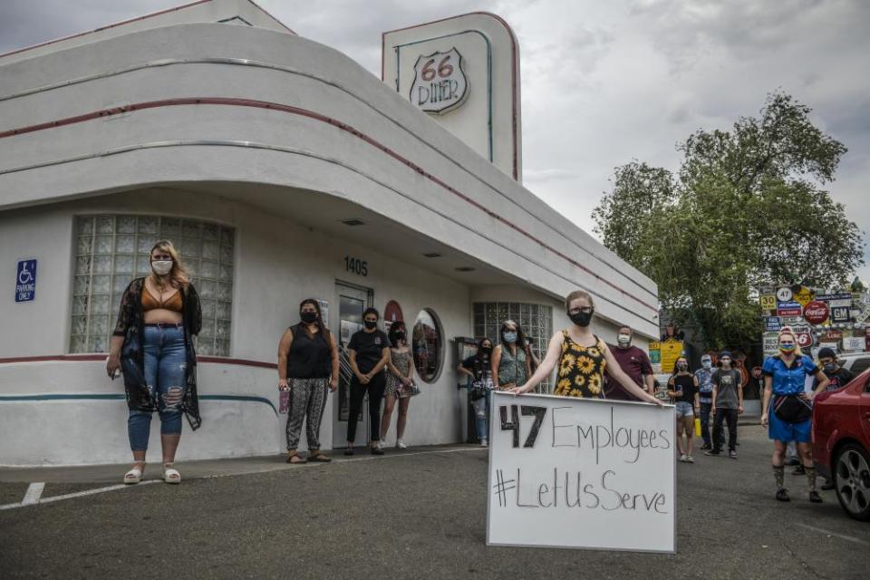 Some of the workers at Route 66 Diner in Albuquerque, New Mexico, gather outside the restaurant during a protest against the governor’s order that restaurants shut down.