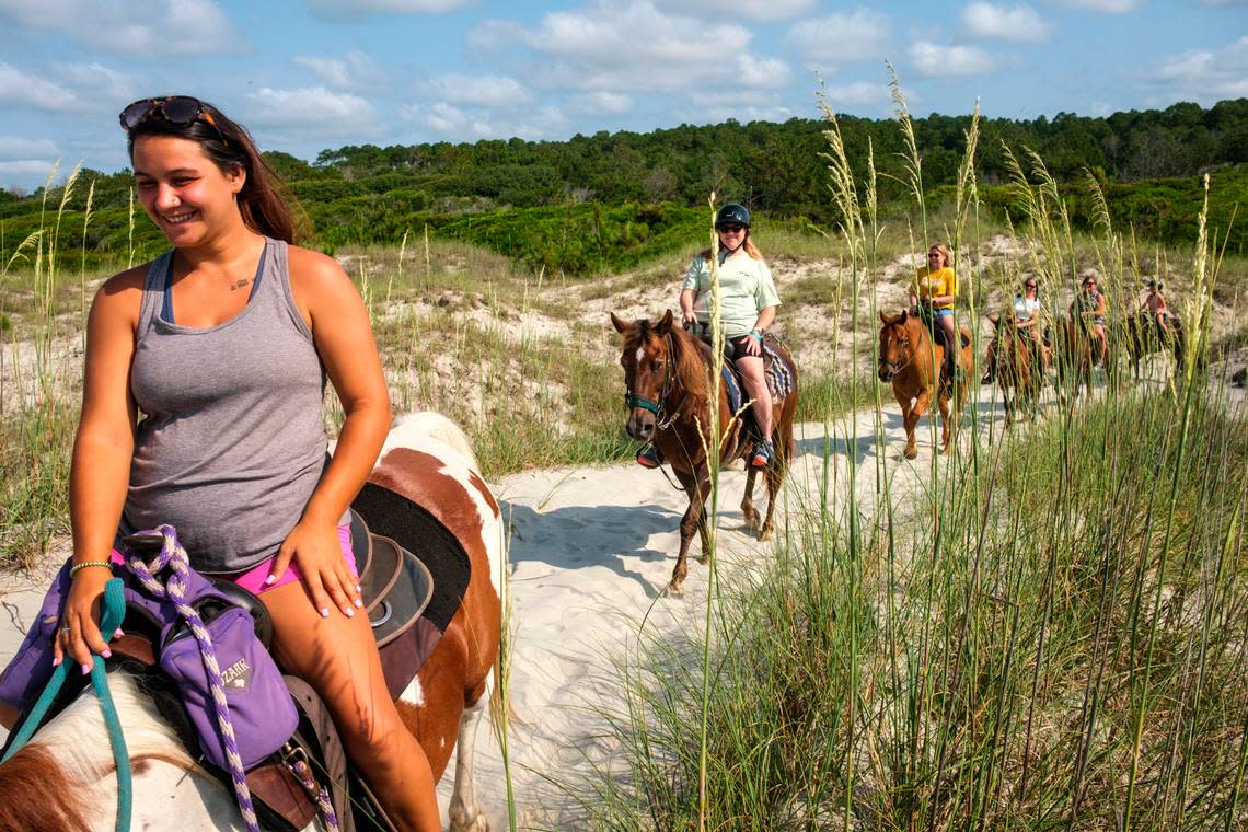 Kaitlyn Brook Stroud leads a trail ride through the dunes to the beach at Waties Island. At Inlet Point Plantation visitors get the unique opportunity to ride on the beach at Waties Island, one of the few undeveloped maritime forest in Horry County. June 16, 2022.