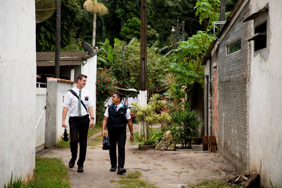 Elders Tanner McKee and Pedro Cabral, missionaries for The Church of Jesus Christ of Latter-day Saints, walk a narrow street in Paranaguá, Brazil, on Saturday, June 1, 2019. | Spenser Heaps, Deseret News