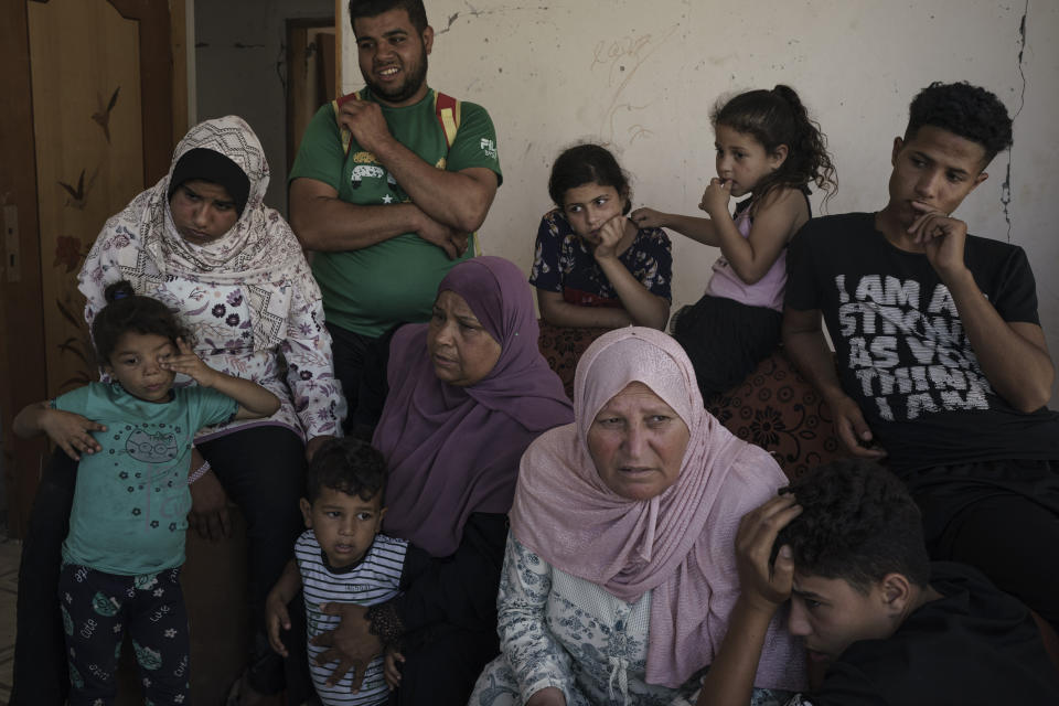 Khaldiya Nassir, center left, sits with other family members near the entrance of her house, heavily damaged by airstrikes in the recent 11-day war in Beit Hanoun, northern Gaza Strip, Sunday, June 13, 2021. (AP Photo/Felipe Dana)