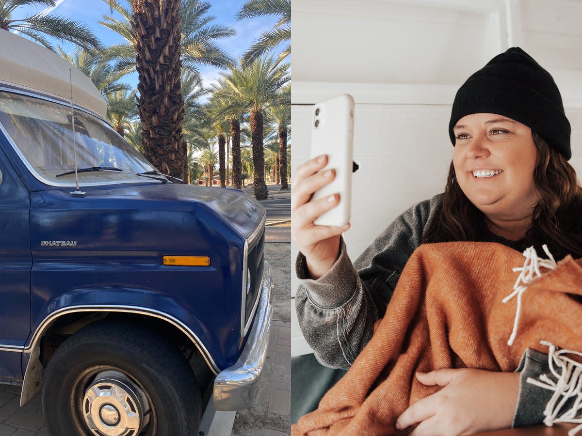 A blue van in a parking lot with palm trees and blue sky in background and the writer smiling at phone while holding an orange blanket in back of van