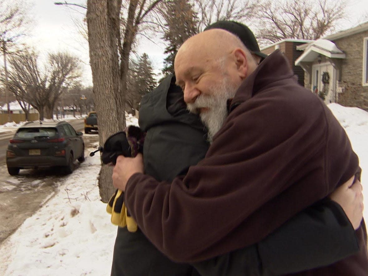 Stan Dimnik, right, meets Mike Napper, who saved Dimnik's two friends from a burning house. (Chanss Lagaden/CBC - image credit)