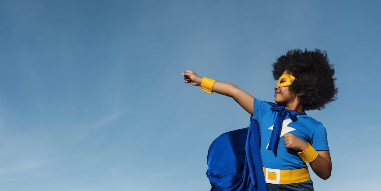 girl with afro playing superhero