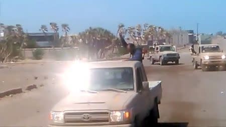 Members of UAE-backed fighters, Yemeni Resistance Giants' Brigade drive the truck near airport on the outskirts of Hodeidah, Yemen, June 19, 2018 in this still image taken from video. YEMENI RESISTANCE GIANTS' BRIGADE/REUTERS