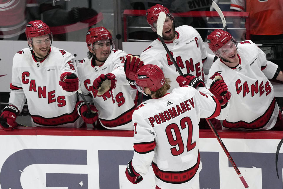 Carolina Hurricanes center Vasiliy Ponomarev (92) celebrates with teammates after scoring in the third period of an NHL hockey game against the Washington Capitals, Friday, Jan. 5, 2024, in Washington. (AP Photo/Mark Schiefelbein)