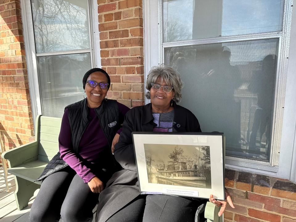 Billie Miles, left, and her cousin Carolyn Simpson Whitley, right, hold a picture of Whitley's fourth great grandfather's steamboat called The Alice. Both Miles and Whitley were in attendance at the Pender County Museum's reopening Thursday afternoon in Burgaw.