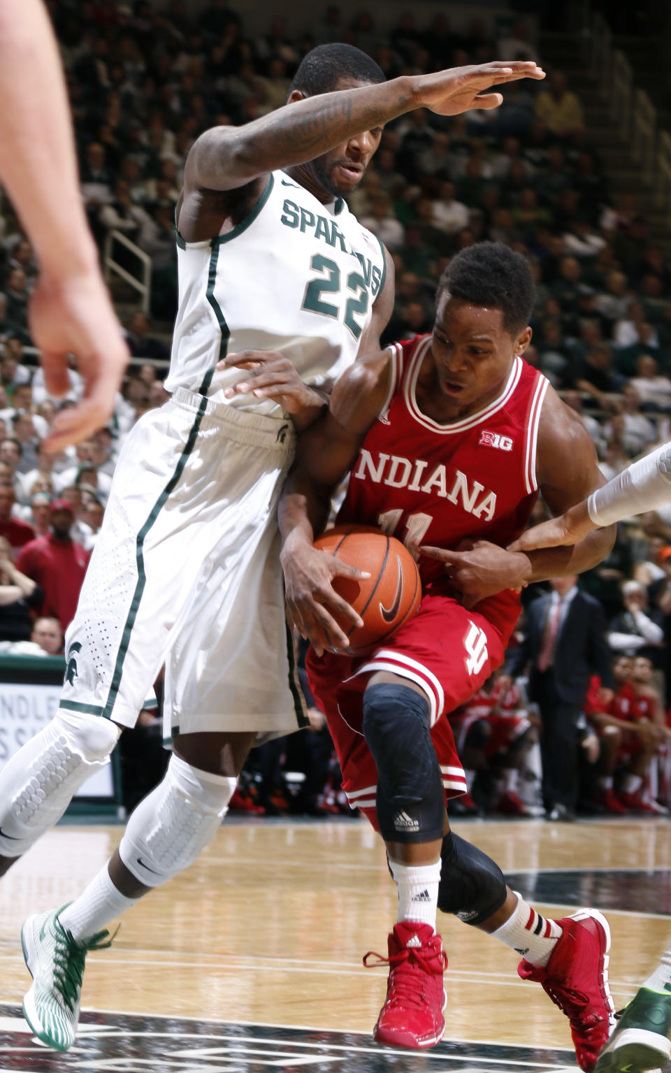 Indiana's Yogi Ferrell, right, drives against Michigan State's Branden Dawson (22) during the first half of an NCAA college basketball game, Tuesday, Jan. 21, 2014, in East Lansing, Mich. (AP Photo/Al Goldis)