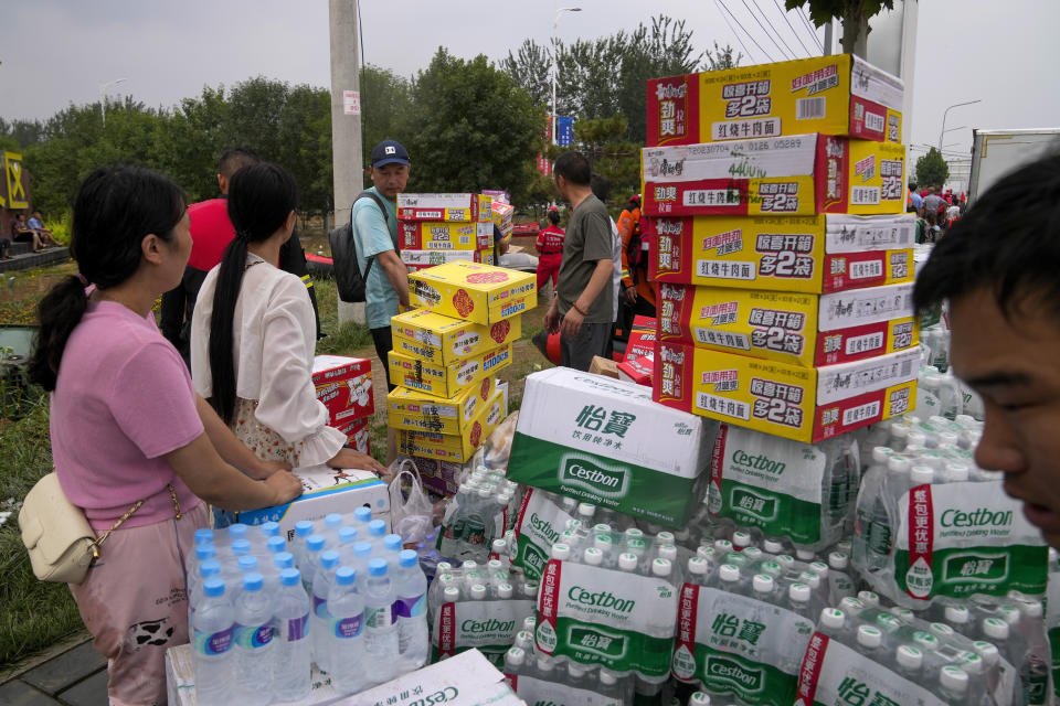 Volunteers prepare food suppliers for trapped residents in the flood-hit Zhuozhou in northern China's Hebei province, south of Beijing, Wednesday, Aug. 2, 2023. China's capital has recorded its heaviest rainfall in at least 140 years over the past few days. Among the hardest hit areas is Zhuozhou, a small city that borders Beijing's southwest. (AP Photo/Andy Wong)