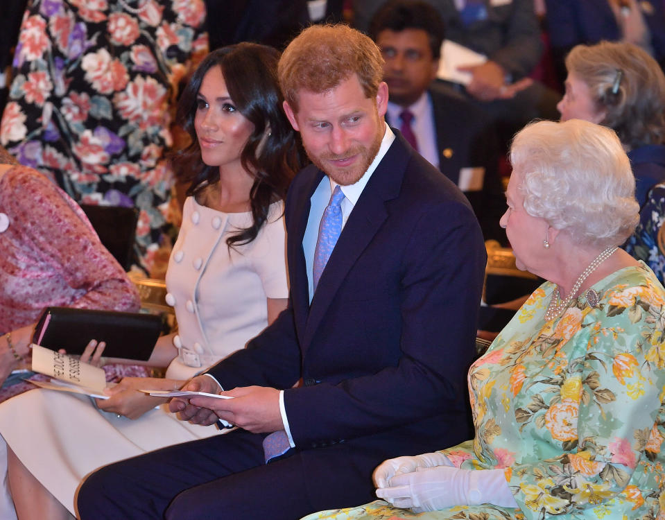 LONDON, ENGLAND - JUNE 26: Queen Elizabeth II with Prince Harry, Duke of Sussex and Meghan, Duchess of Sussex at the Queen's Young Leaders Awards Ceremony at Buckingham Palace on June 26, 2018 in London, England. The Queen's Young Leaders Programme, now in its fourth and final year, celebrates the achievements of young people from across the Commonwealth working to improve the lives of people across a diverse range of issues including supporting people living with mental health problems, access to education, promoting gender equality, food scarcity and climate change.  (Photo by John Stillwell - WPA Pool/Getty Images)