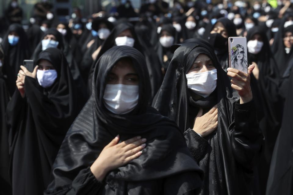 FILE - In this Sunday, Aug. 30, 2020 file photo, people wearing protective face masks to help prevent spread of the coronavirus mourn during an annual ceremony commemorating Ashoura in Tehran, Iran. The confirmed death toll from the coronavirus has gone over 50,000 in the Middle East as the pandemic continues. That's according to a count Thursday, Sept. 3, 2020, from The Associated Press, based on official numbers offered by health authorities across the region. (AP Photo/Ebrahim Noroozi, File)