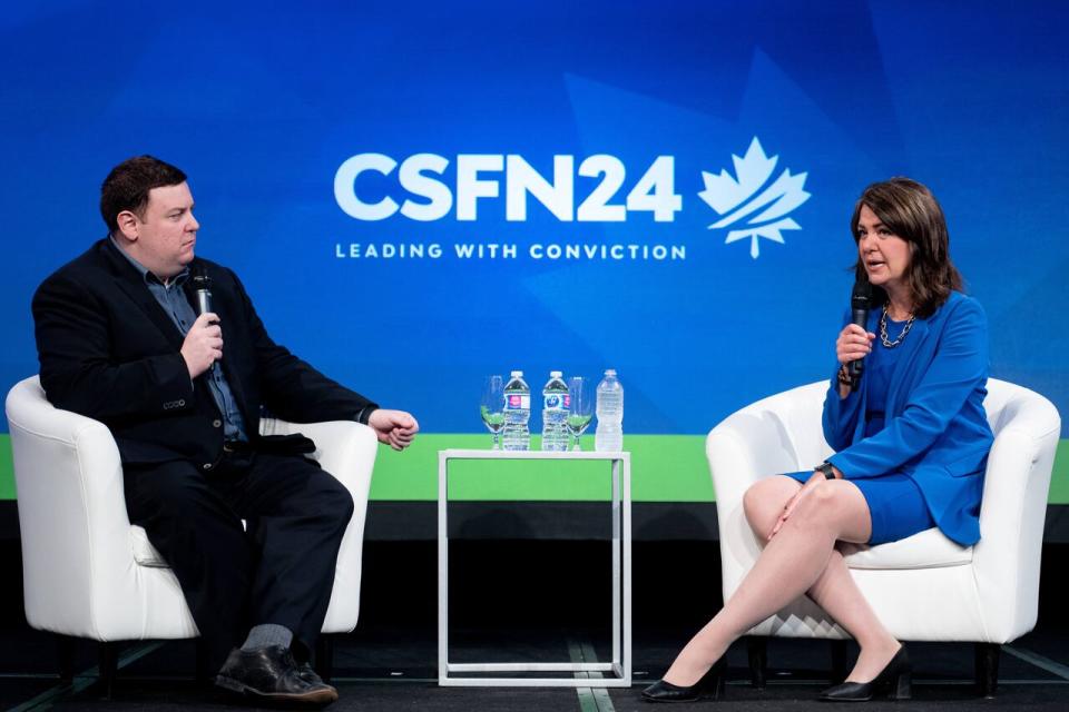 Alberta Premier Danielle Smith, right, speaks during a fireside chat with True North journalist Andrew Lawton during the Canada Strong and Free Network event in Ottawa, on Friday, April 12, 2024. THE CANADIAN PRESS/Spencer Colby