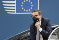 FILE - In this Thursday, June 24, 2021 file photo, Poland's Prime Minister Mateusz Morawiecki arrives for an EU summit at the European Council building in Brussels. When Hungary and Poland joined the European Union in 2004, after decades of Communist domination, they thirsted for Western democratic standards and prosperity yet, 17 years later, as the EU ramps up efforts to rein in democratic backsliding in both countries, some of the governing right-wing populists in Hungary and Poland are comparing the bloc to their former Soviet oppressors — and flirting with the prospect of exiting the bloc. (Johanna Geron/Pool Photo via AP, File)