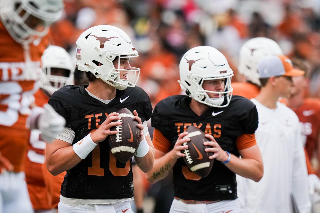 Texas quarterbacks Arch Manning, left, and Quinn Ewers, right, warm up side by side before last Saturday's Orange-White spring game at Royal-Memorial Stadium. They give Texas a solid duo at quarterback; Ewers is entering his third season as the starter, but also has missed nearly six full games out of a possible 27 games in that span.