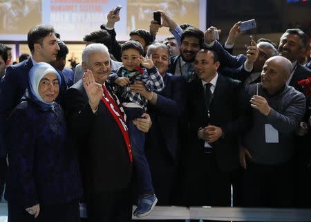 Turkish Prime Minister and leader of the ruling AK Party Binali Yildirim greets his supporters during a campaign meeting for the April 16 constitutional referendum, in Ankara, Turkey, February 25, 2017. REUTERS/Umit Bektas