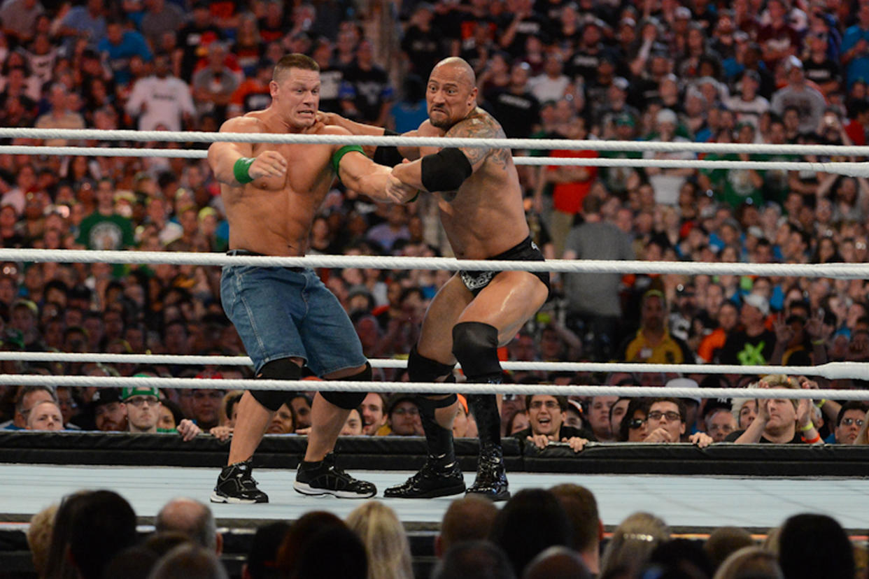 Dwayne “the Rock” Johnson and John Cena in action during WrestleMania 28 at Sun Life Stadium on April 1, 2012, in Miami Gardens, Florida. (Photo by Ron Elkman/Sports Imagery/Getty Images)