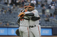 Baltimore Orioles relief pitcher Mychal Givens, right, celebrates with catcher Austin Wynns after a baseball game against the New York Yankees at Yankee Stadium, Sunday, Sept. 23, 2018, in New York. (AP Photo/Seth Wenig)