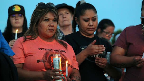 PHOTO: Community members hold candles during a prayer vigil at Hills Church, May 15, 2023, in Farmington, N.M., after a gunman killed three people and injured six others including two police officers before he was killed. (Susan Montoya Bryan/AP)