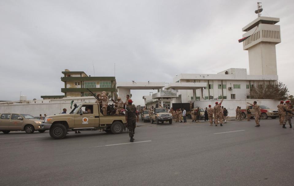 Members of the Libyan army are pictured in front of the headquarters of the Tripoli Military Region as the army prepares for deployment, in Tripoli