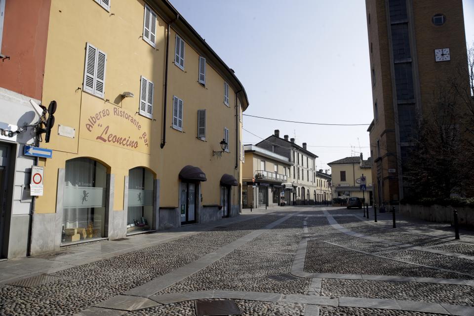 A deserted street in the town of Codogno, near Lodi, Northern Italy, Saturday, Feb. 22, 2020. A dozen northern Italian towns were on effective lockdown Saturday after the new virus linked to China claimed two fatalities in Italy and sickened an increasing number of people who had no direct links to the origin of the virus. The secondary contagions prompted local authorities in towns in Lombardy and Veneto to order schools, businesses and restaurants closed, and to cancel sporting events and Masses. (AP Photo/Luca Bruno)