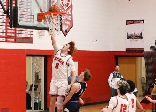 New Boston Huron's Chad Martin scores a basket during a 64-51 win over Trenton Monday night. Martin scored a career-high 29 points.