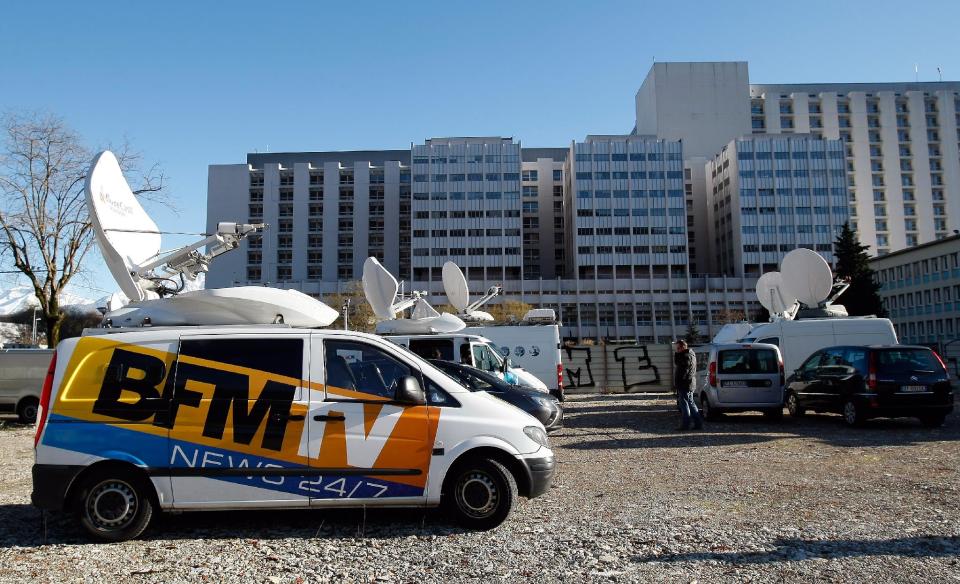 A TV van is parked in front of the Grenoble hospital, French Alps, Sunday, Jan. 5 , 2014, where former seven-time Formula One champion Michael Schumacher is being treated after sustaining a head injury during a ski accident. Schumacher has been in a medically induced coma since Sunday, Dec. 29, 2013, when he struck his head on a rock while on a family vacation. (AP Photo/Claude Paris)