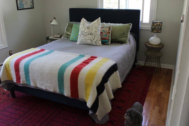 Bed with decorative pillows and quilt on a bed.