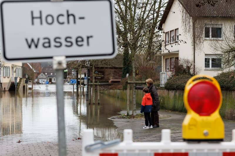 View of a road closure with the sign "Flood". The water level of the Weser has risen significantly in recent days. Friso Gentsch/dpa