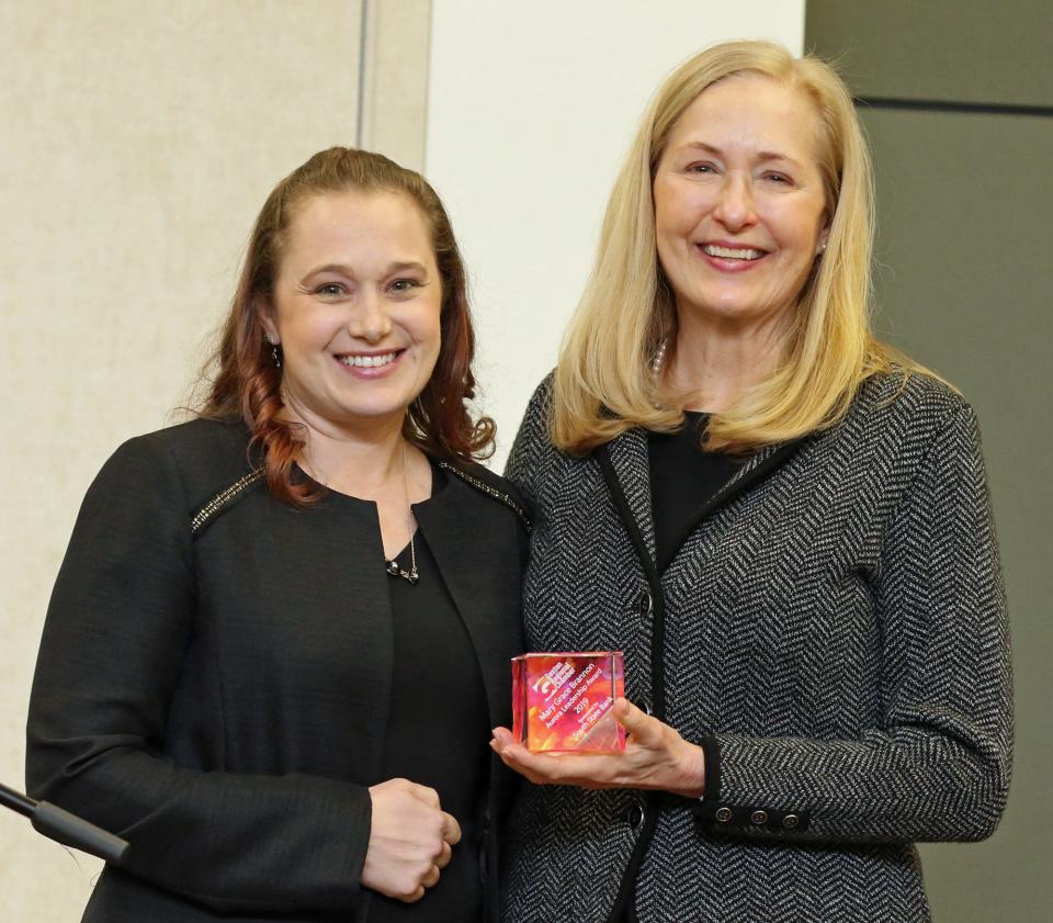 Andrea Grenier, left, is presented the Aurora Award by Senior Vice President and Market President at South State Bank Janet Sarn during the Gaston Business Association Annual Meeting & Celebration held Friday, Dec. 2, 2022, at the Gastonia Conference Center.