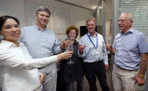 Scientist Peter J.Ratcliffe, second from right, celebrates with his team at the University in Oxford, England, Monday, Oct. 7, 2019. Two Americans and a British scientist won the 2019 Nobel Prize for Physiology or Medicine for discovering how the body’s cells sense and react to oxygen levels, work that has paved the way for new strategies to fight anemia, cancer and other diseases Drs. William G. Kaelin Jr. of Harvard University, Gregg L. Semenza of Johns Hopkins University and Peter J. Ratcliffe at the Francis Crick Institute in Britain and Oxford University will share the 9 million kronor ($918,000) cash award.(AP Photo/Frank Augstein)