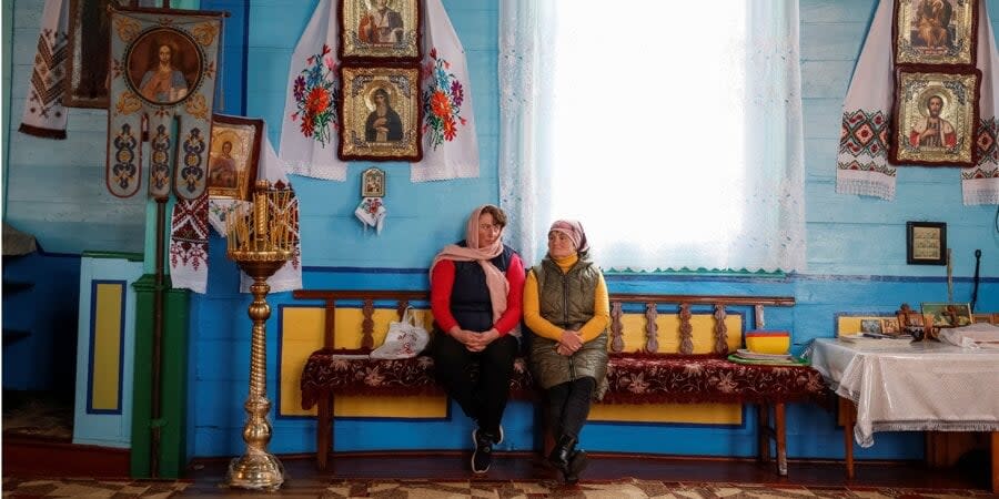 Two women in the church in Grabivtsi, whose congregation moved from the UPC of the MP to the OCU
