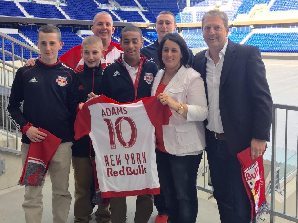 Tyler Adams, front center, poses with his mother Melissa Russo, stepfather Darryl Sullivan (back) and Sullivan’s sons, as well as James Grant Sports global director Lyle Yorks, right.