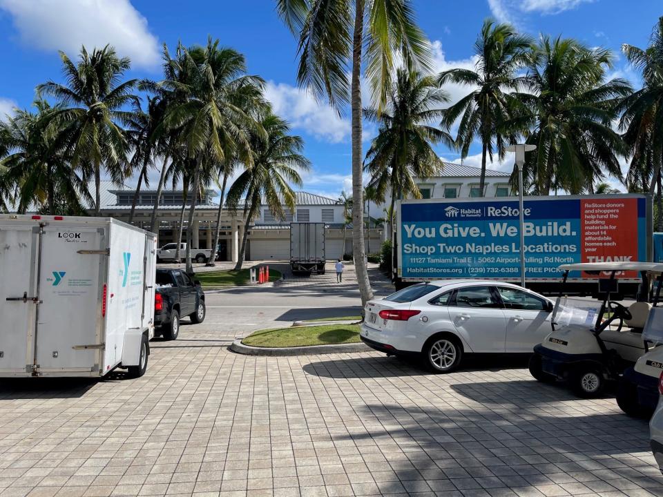 Trucks for Habitat for Humanity in Collier County and the Greater Naples YMCA leave with donations from Naples Beach Club.